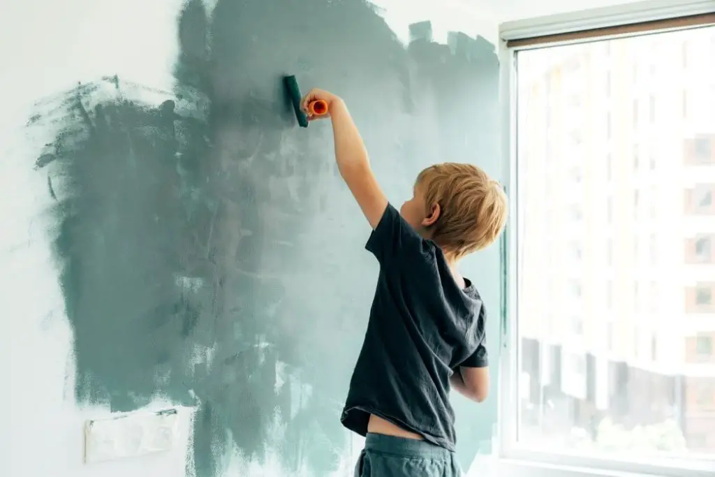 child painting a wall